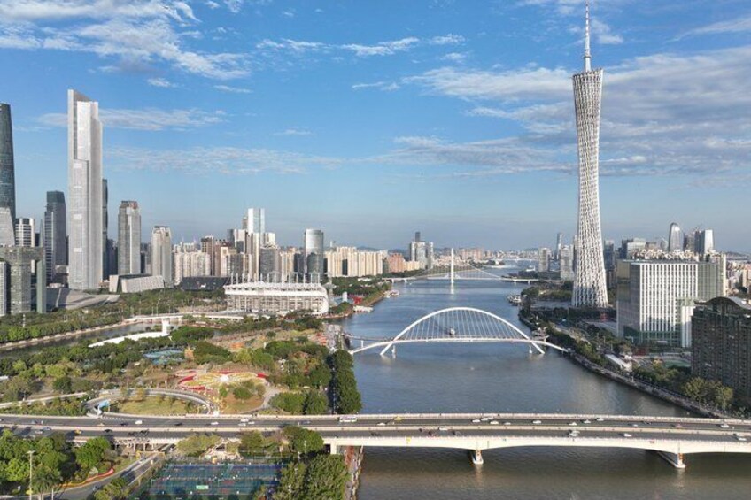 A cityscape with a prominent tower, a river, and a bridge. 4