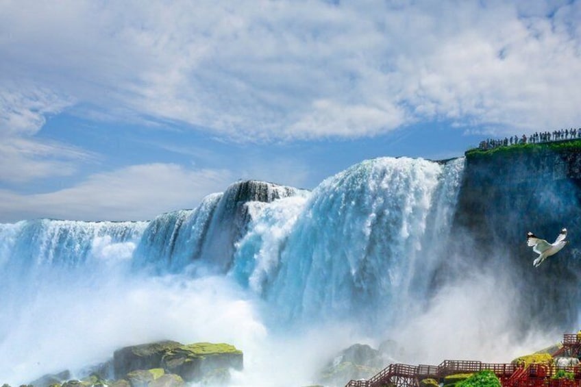 A waterfall with a person jumping in the air. 4