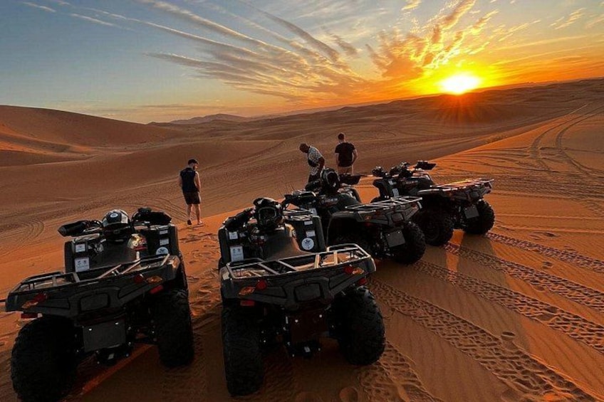 Off-road vehicles on a desert trail with a sunset in the background. 3