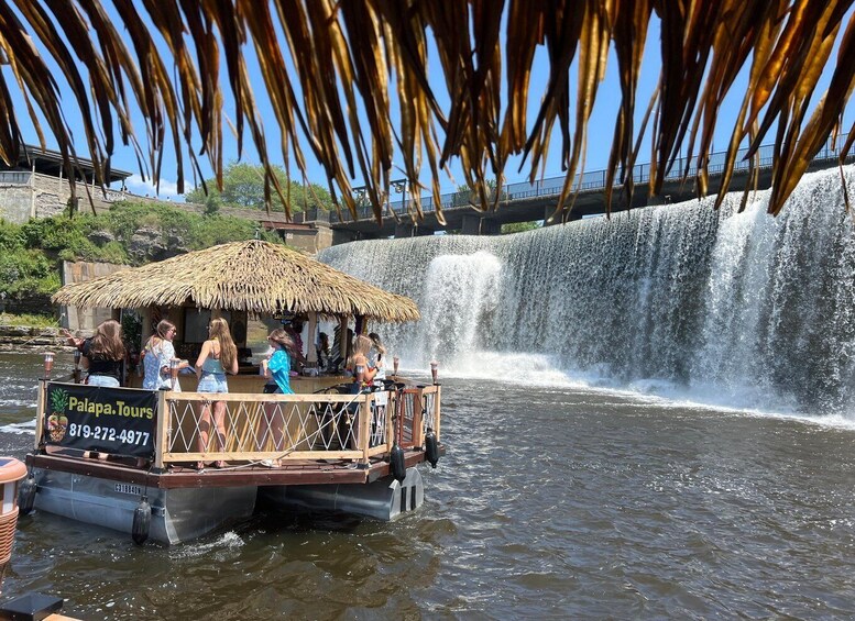 Un paseo en barco con techo de paja, pasajeros disfrutando de la vista de una cascada. 5