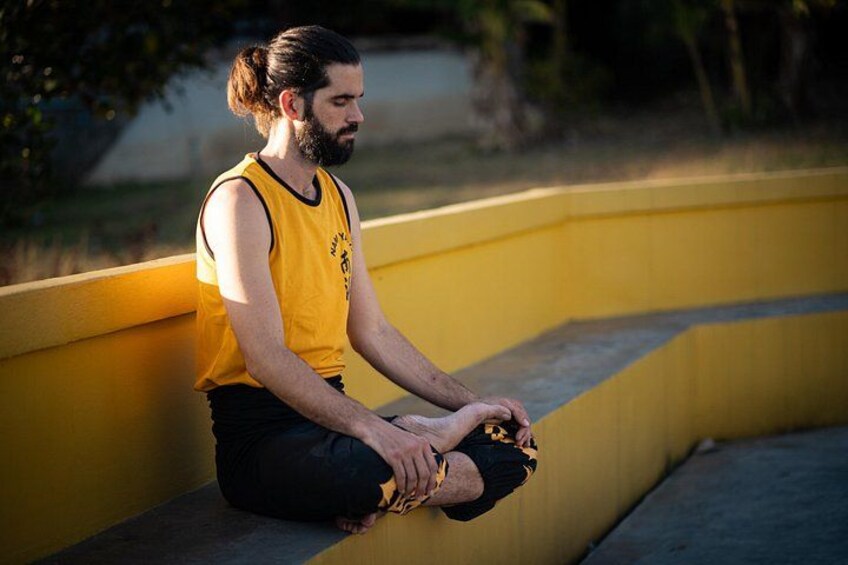 A person sitting on a yellow bench outdoors. 2