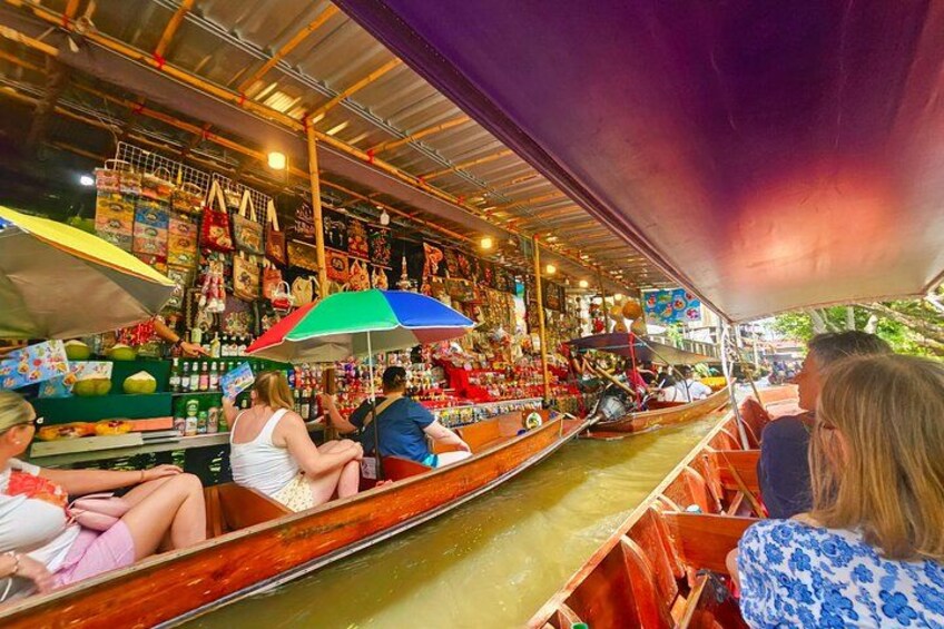 A boat ride through a market with stalls selling various goods. 5