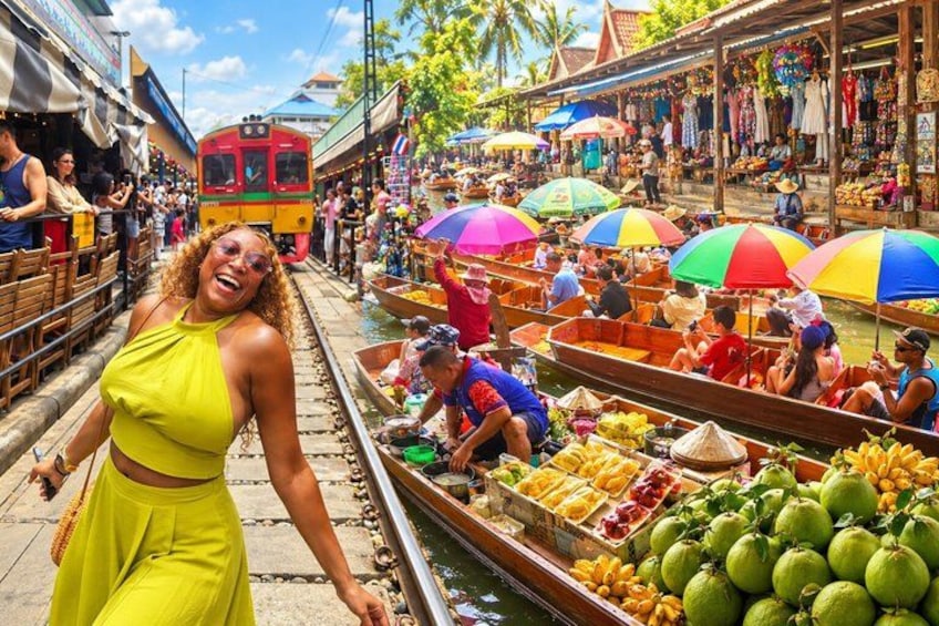 A market scene with boats, people, and a train. 1