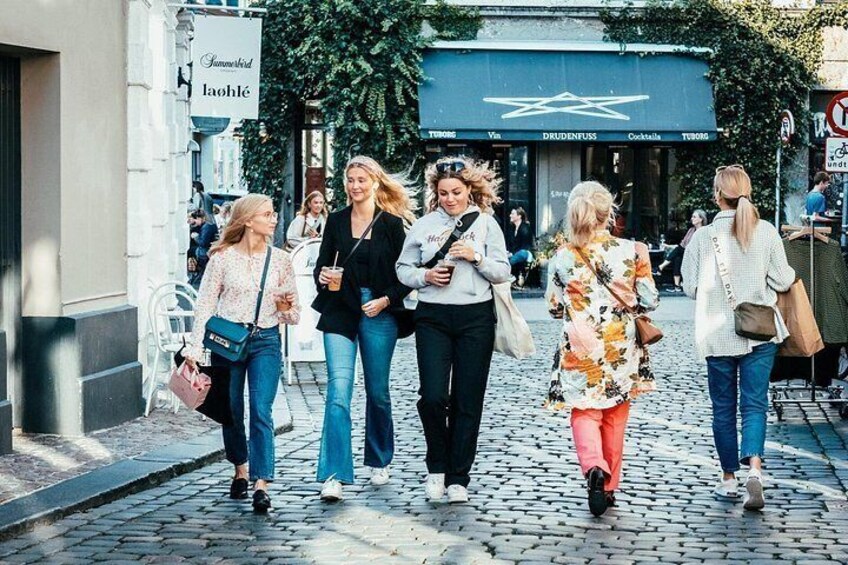 A cobblestone street with pedestrians. 2