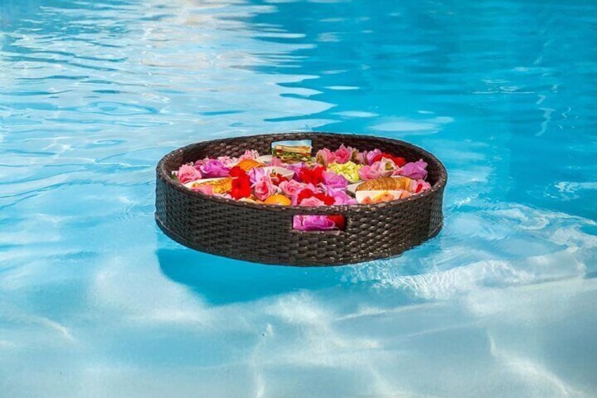 A floating basket with colorful flowers in a pool. 3