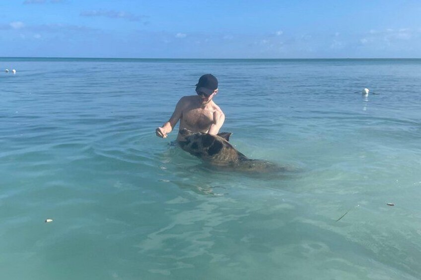Una persona en agua cristalina con un pez grande. 2