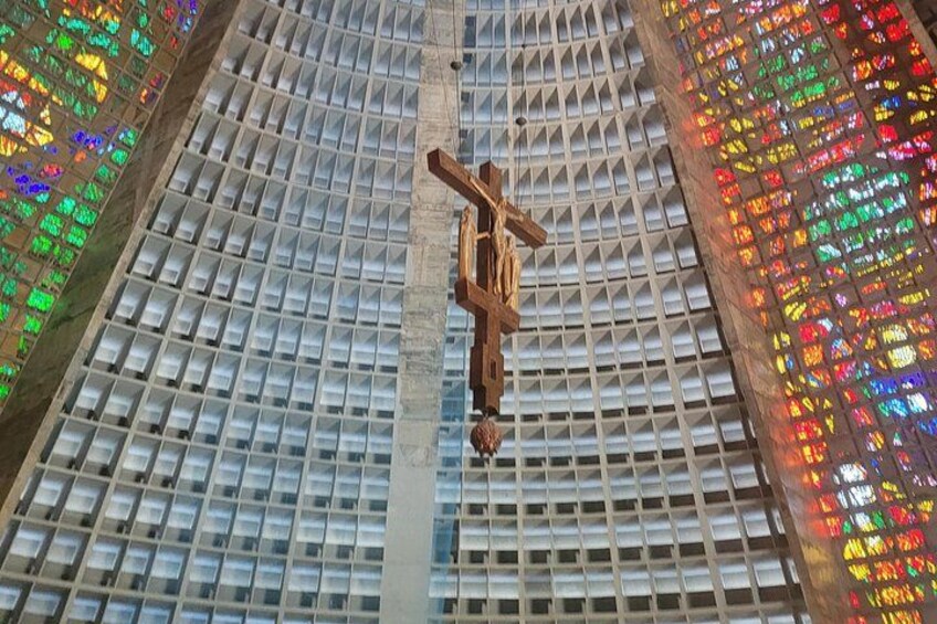 A large building with a grid of windows and a wooden cross structure. 2