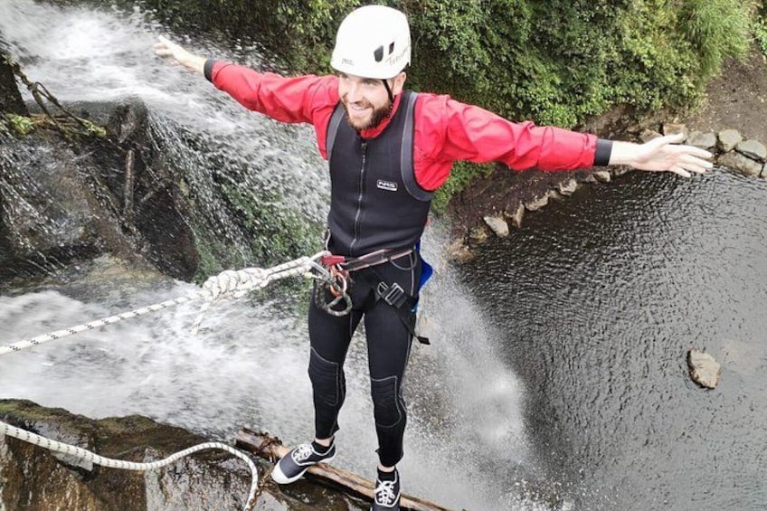 A person rappelling down a waterfall. 1