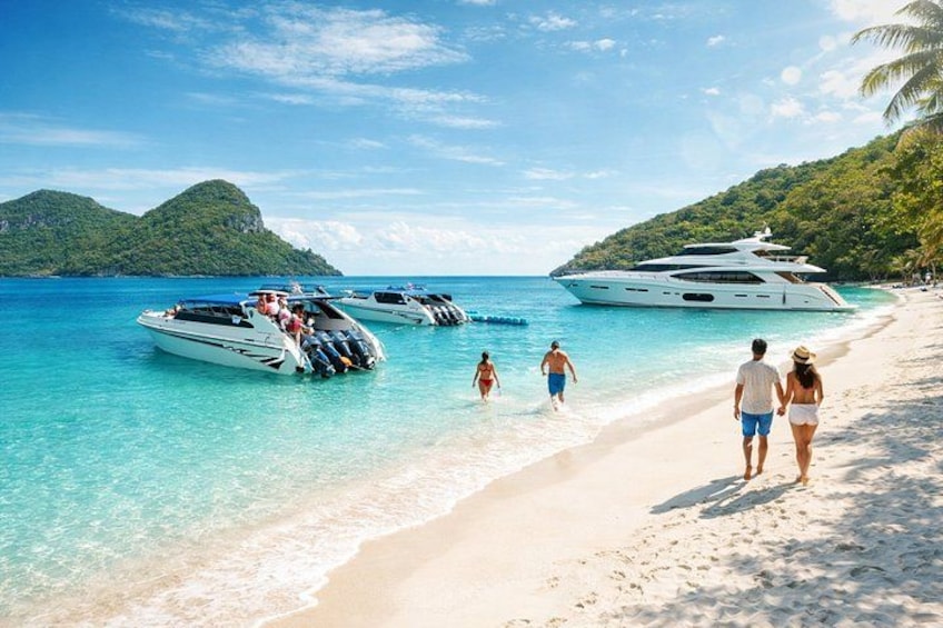 A beach with yachts, people walking, and a clear blue sea. 4