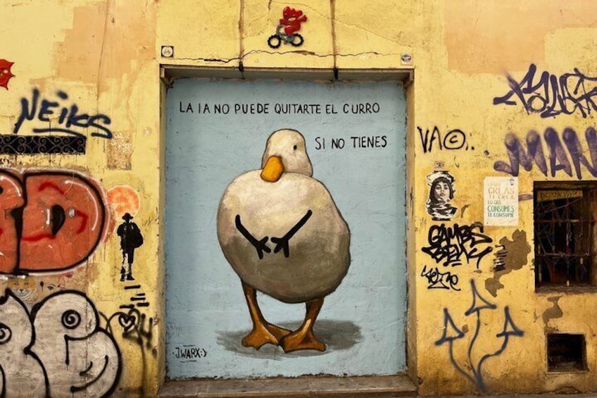 Un mural con una ganso en la pared, con grafitis y texto. 2
