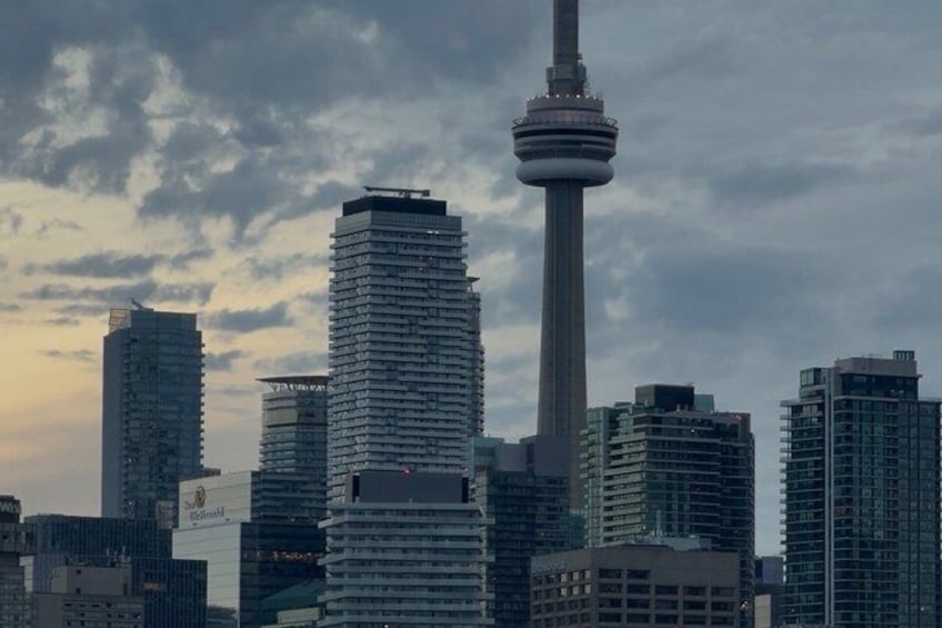 A city skyline with modern high-rise buildings and a prominent tower. 5