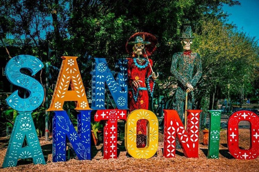 Kleurrijke letters met de naam 'SANTONIO' en skeletfiguren in traditionele kledij. 3