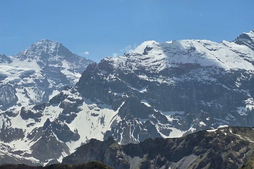 Snow-covered mountain peaks under a clear sky. 3