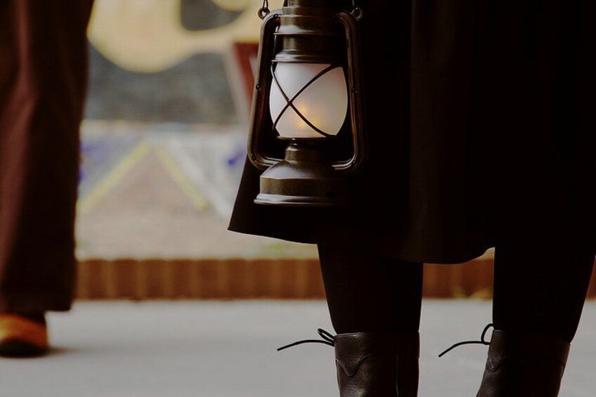 A person holding a lantern. 3