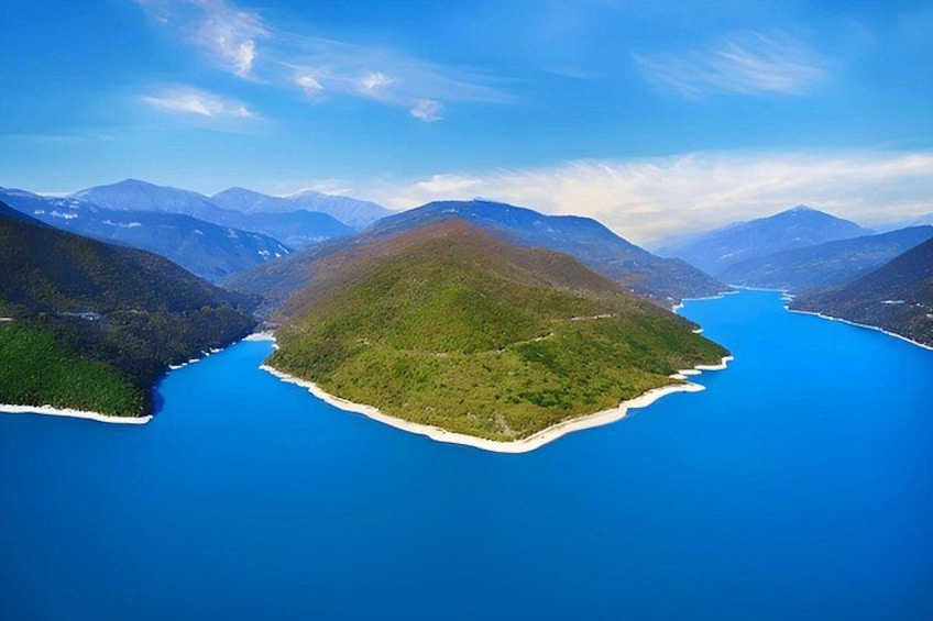 A mountainous island surrounded by a deep blue lake. 4
