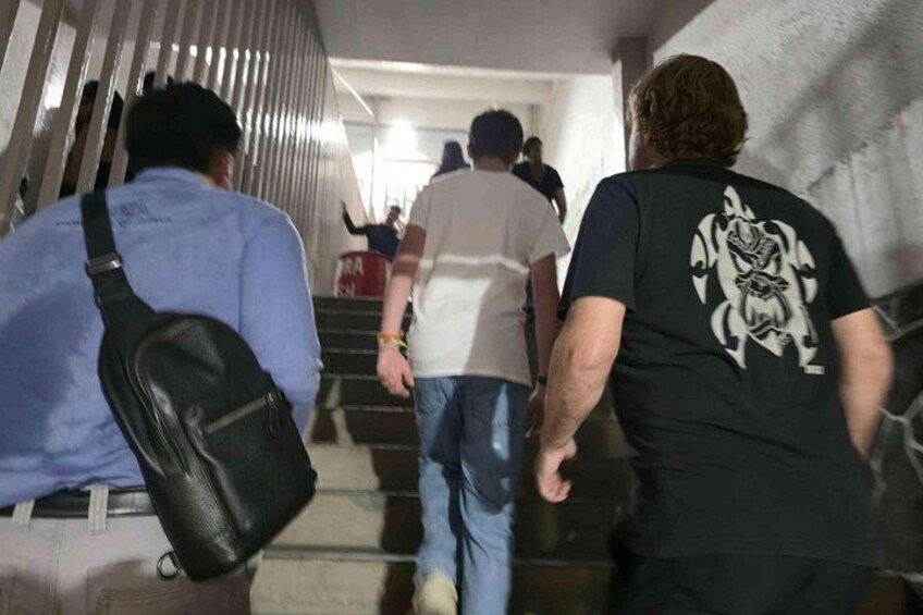People walking up a staircase in an indoor setting. 2