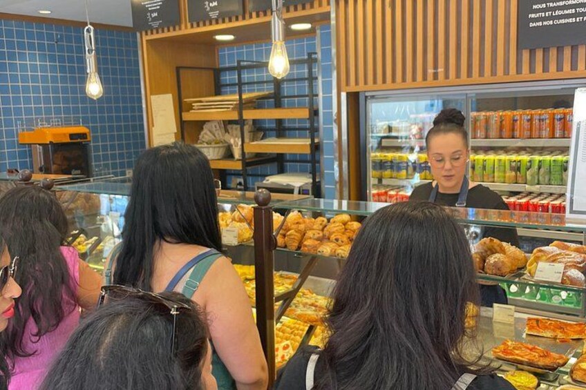 A bakery display with pastries and a cashier. 4