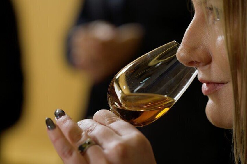 A person holding a wine glass. 3