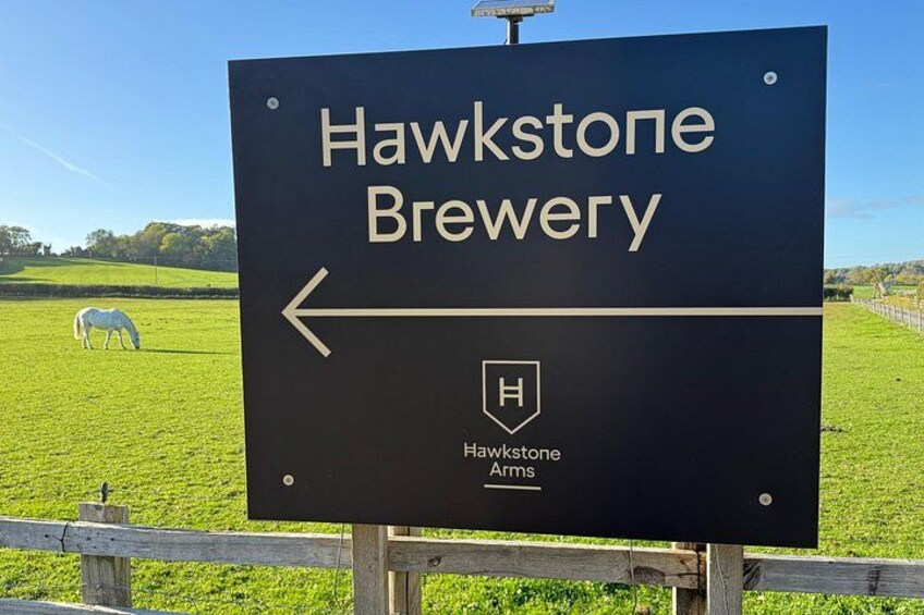 A sign for Hawkstone Brewery with a directional arrow. 3
