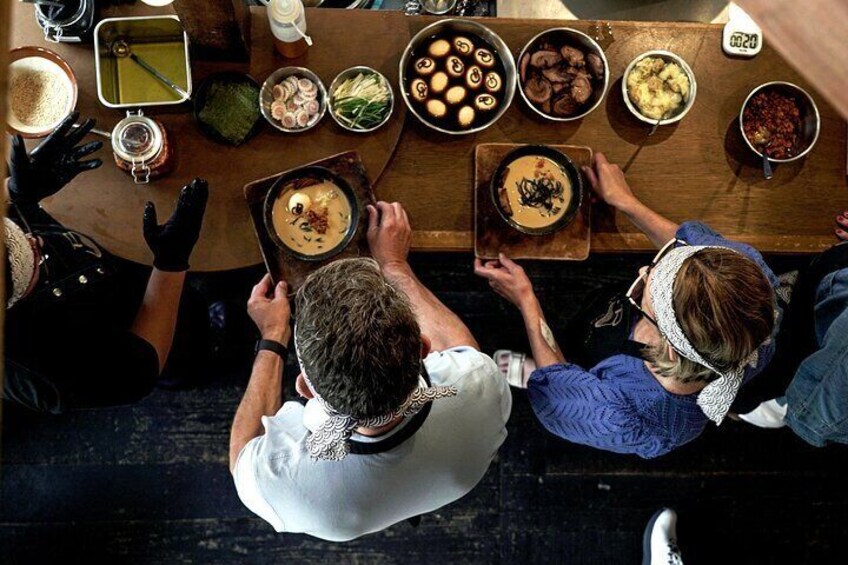 A group of people at a table with various dishes and drinks. 4