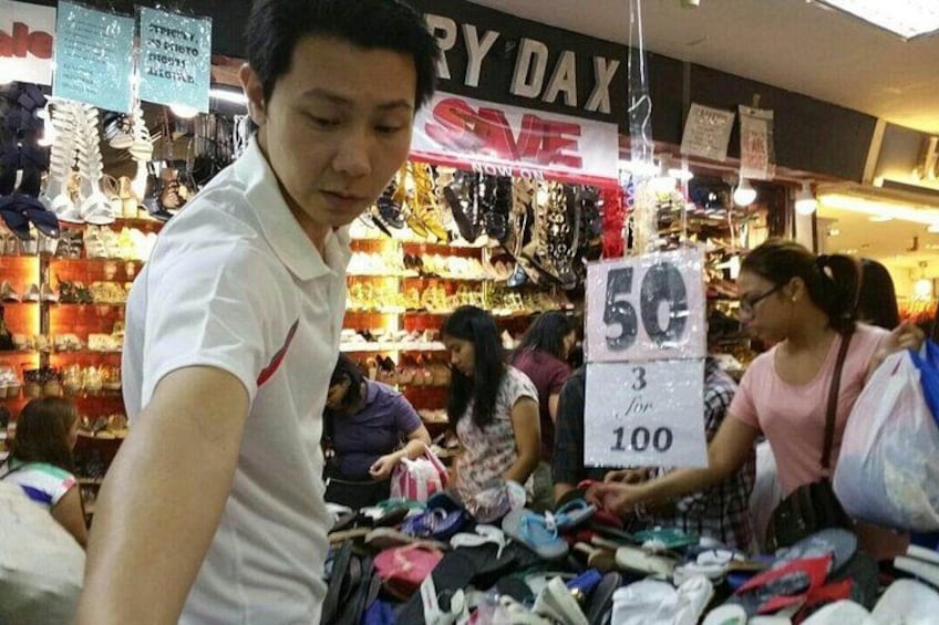 A market with various items on display, including a sign advertising a sale. 3