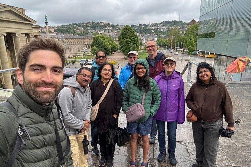 A group of people standing on a bridge with a cityscape in the background. 5