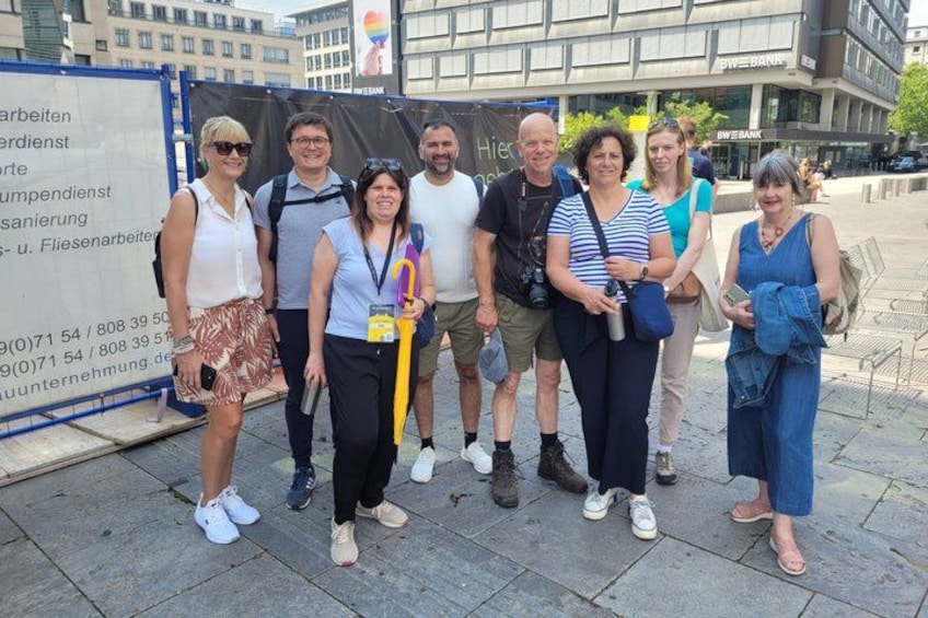 A group of people standing in an urban setting with a construction site in the background. 3