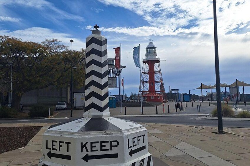 A lighthouse, a chevron sign, and a red and white tower. 2