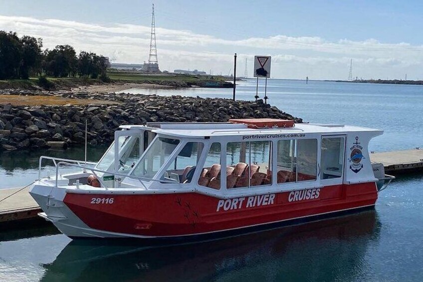 Un bateau rouge et blanc, baptisé « Port River Cruises », était amarré dans une marina. 4