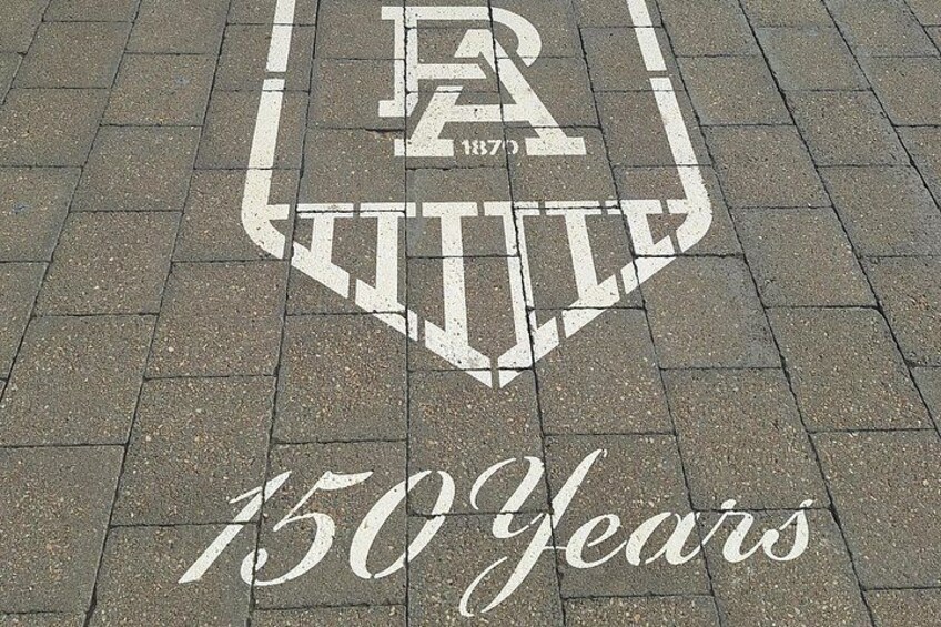 A logo with the letters 'ER' and '1870' inside a shield, and the text '150 Years' below it. 3