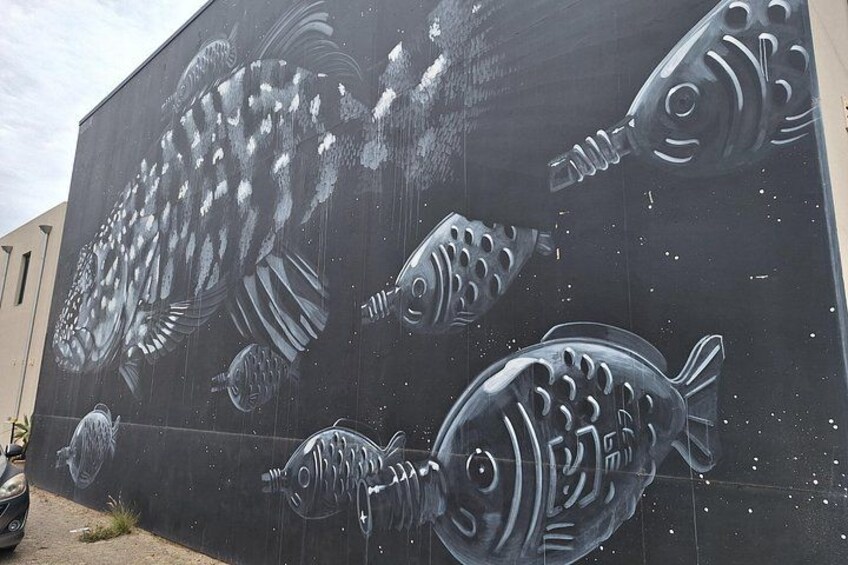 A mural of stylized fish on a wall. 4