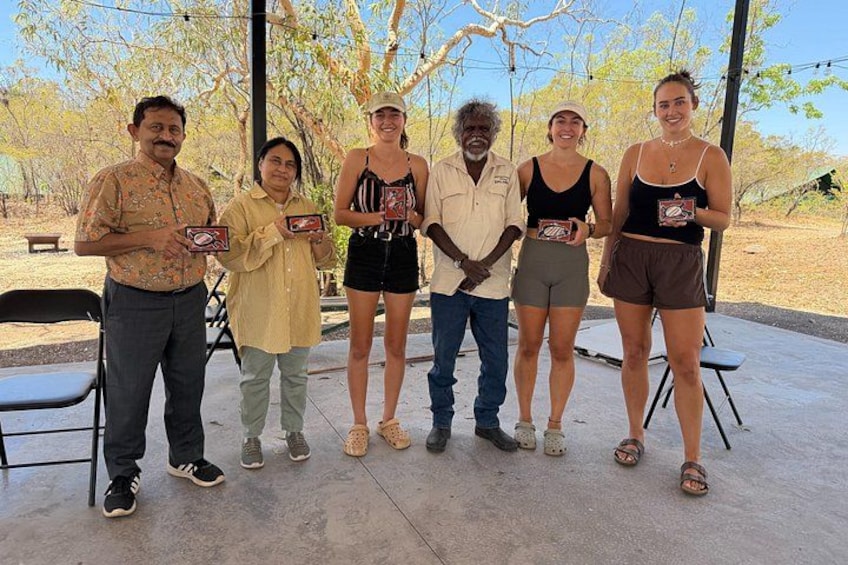 A group of people standing outdoors, holding plaques. 2