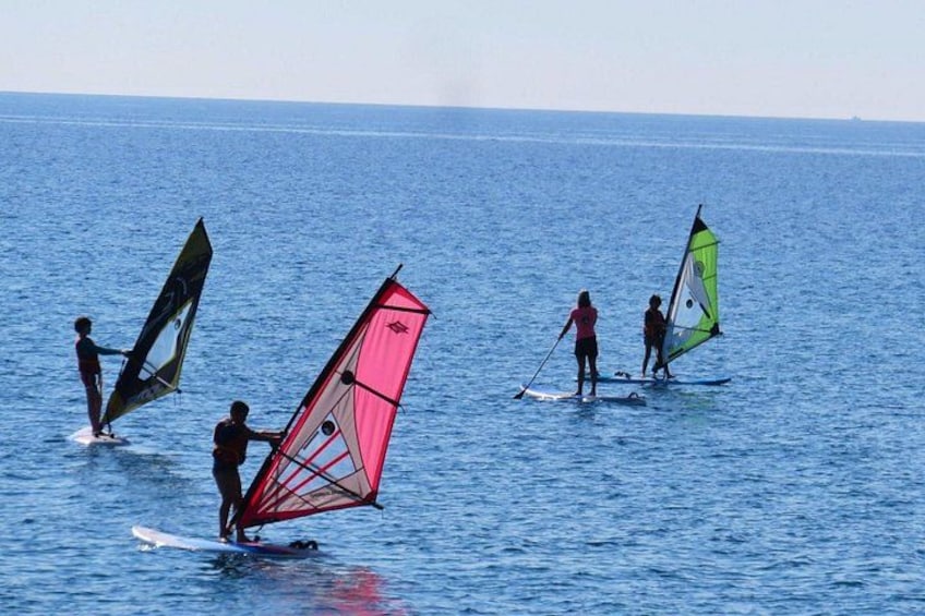 Personer windsurfer på et roligt hav. 3