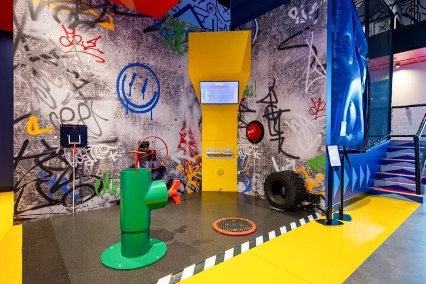 A graffiti-covered wall, a yellow door, and a blue staircase. 2