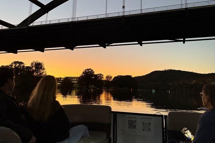 A sunset over a river with a bridge in the background. 5