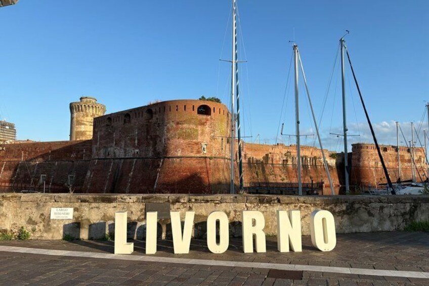 A historic fort with the word 'LIVORNO' in the foreground. 3