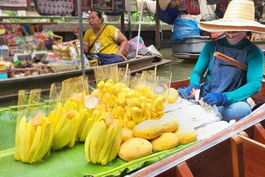 A person selling bananas at a market. 4