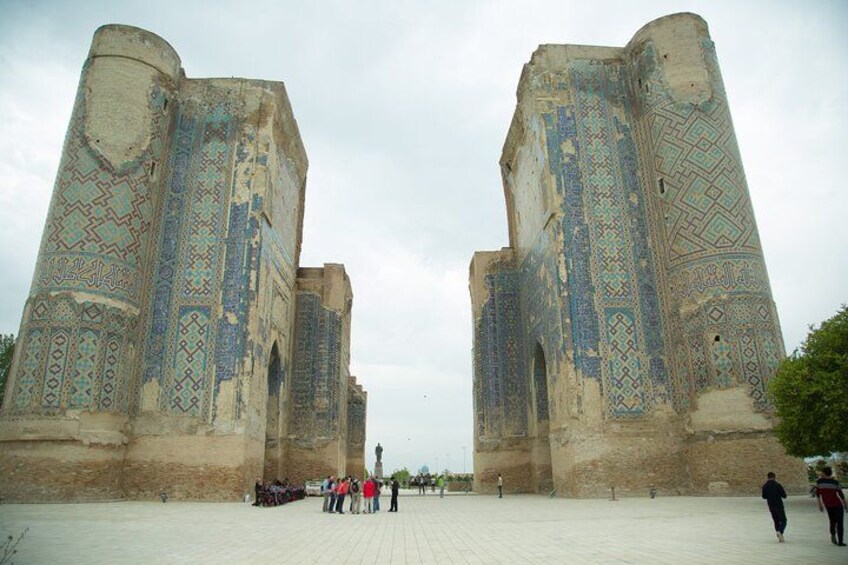 A historic building with intricate tile work and two large towers. 2