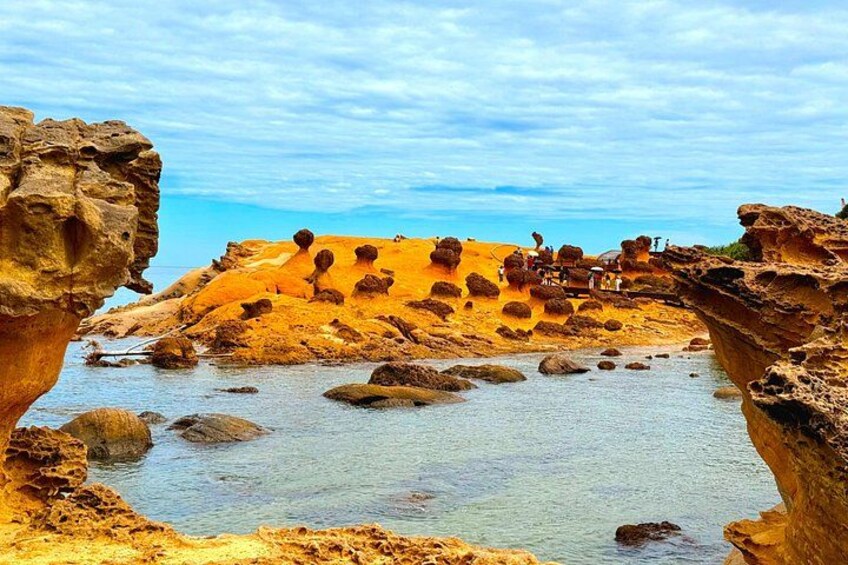 A coastal landscape with rock formations and a body of water. 4