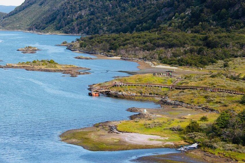 Paesaggio costiero con un ponte, un fiume e una collina boscosa. 4