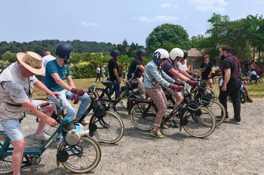 A group of people on bicycles in a line, possibly participating in a race or group ride. 4
