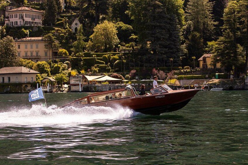 Un bateau à moteur sur l’eau, portant un drapeau, entouré d’immeubles et d’arbres. 4