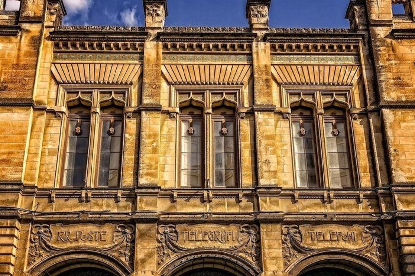 A building facade with ornate window frames and decorative carvings. 2