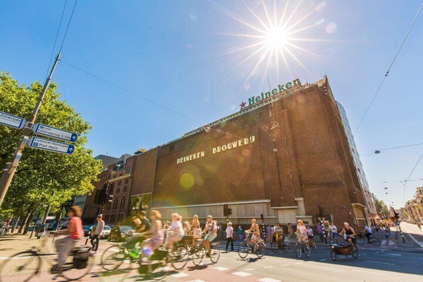 A large building with the Heineken logo and the text "Heineken Brouwerij" on its facade. 1