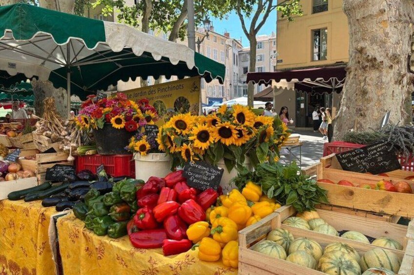 A market stall with fresh vegetables and sunflowers. 3