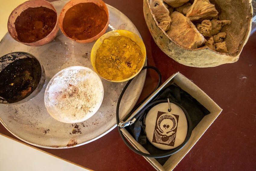 A tray with various powders and a small box with a lid. 5