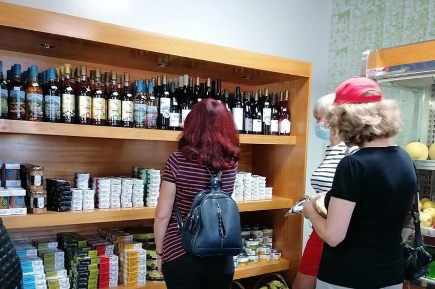 A store with shelves of wine bottles and boxes of products. 3