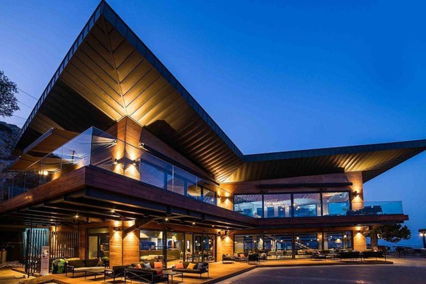 A modern building with a sloped roof and large windows. 4