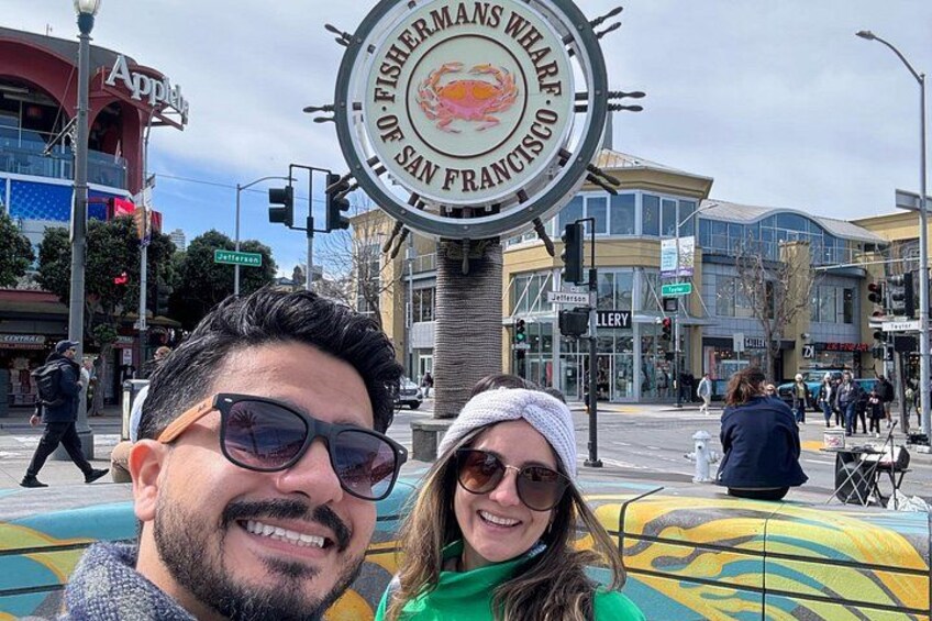 A sign with the text 'FISHERMANS WEAR OF SAN FRANCISCO' and a street scene with pedestrians and buildings. 2
