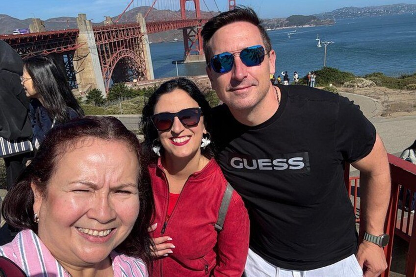 A group of people near a bridge with a view of the water. 4